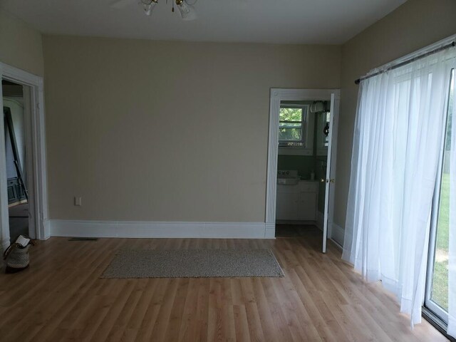 empty room with light hardwood / wood-style flooring