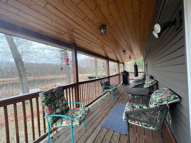 wooden terrace featuring a grill