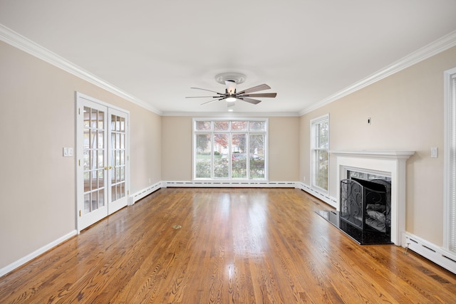 unfurnished living room featuring hardwood / wood-style floors, a baseboard radiator, ceiling fan, and crown molding