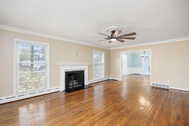 unfurnished living room with ceiling fan with notable chandelier, baseboard heating, dark hardwood / wood-style flooring, and ornamental molding