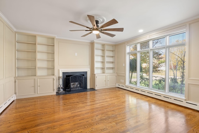 unfurnished living room with ceiling fan, a baseboard radiator, light hardwood / wood-style flooring, and built in shelves