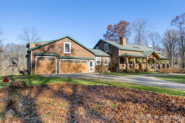 view of front of house with a porch and a garage