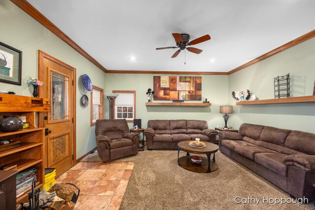 tiled living room with ceiling fan and crown molding