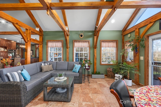 living room featuring vaulted ceiling with beams