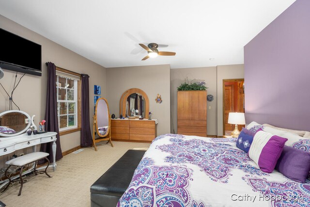 bedroom featuring ceiling fan and light carpet