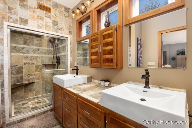 bathroom featuring vanity and a shower with shower door