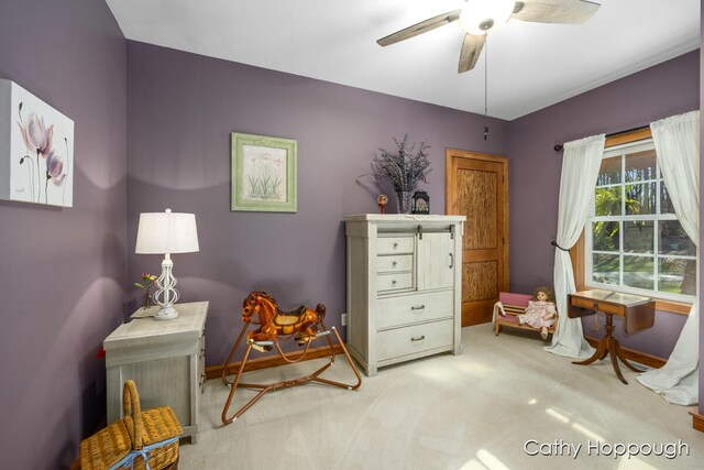 living area featuring ceiling fan and carpet floors