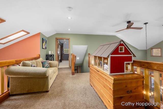 interior space with ceiling fan and vaulted ceiling with skylight