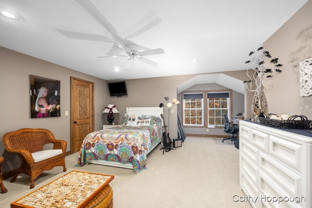 bedroom featuring light carpet, vaulted ceiling, and ceiling fan