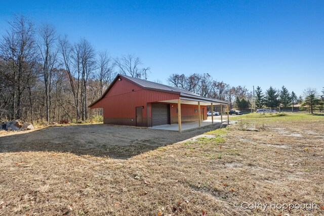 view of home's exterior with an outbuilding and a garage