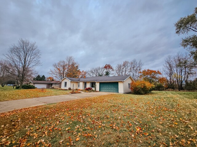 ranch-style home with a garage and a front yard