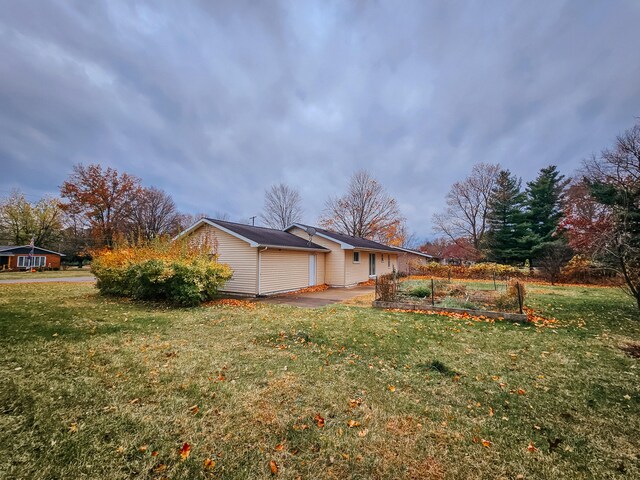 view of side of home featuring a lawn