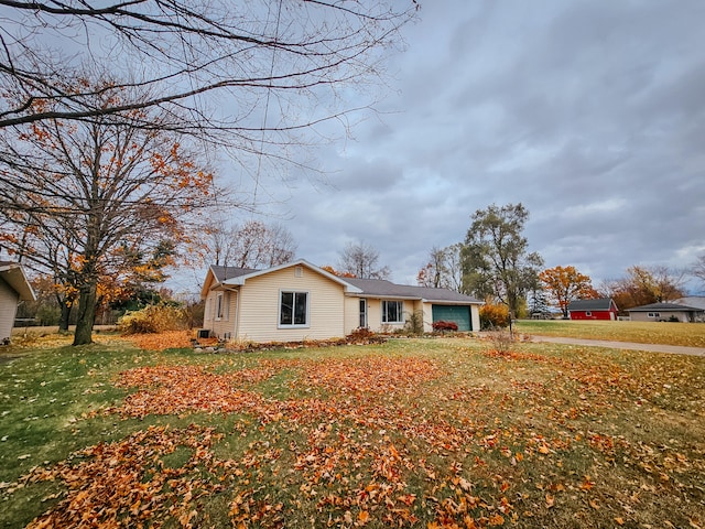 view of side of home with a garage and a yard