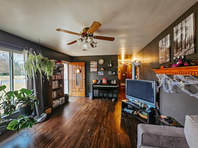 living room featuring wood-type flooring and ceiling fan