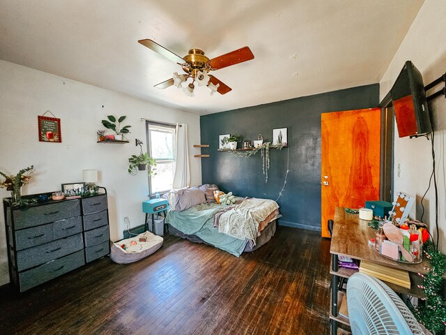 bedroom with ceiling fan and dark hardwood / wood-style flooring