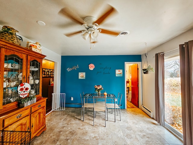 dining area with baseboard heating and ceiling fan