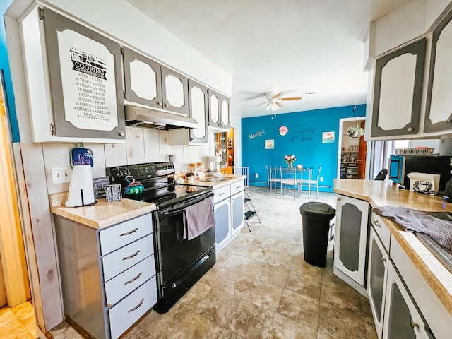 kitchen featuring black electric range oven, ceiling fan, and gray cabinetry