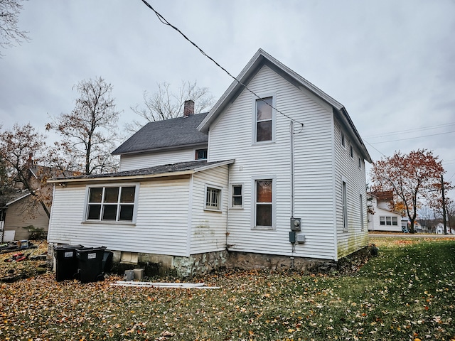 back of house with a lawn