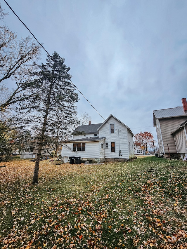 rear view of house with a lawn