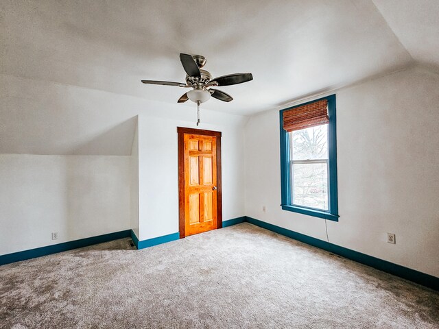 additional living space featuring ceiling fan, lofted ceiling, and carpet floors