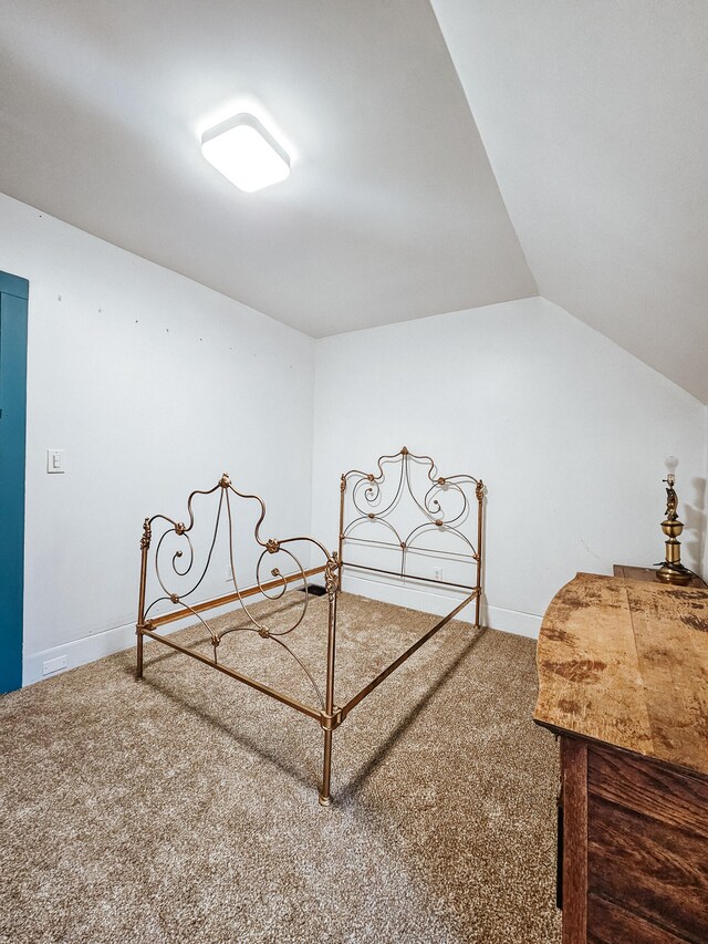 carpeted bedroom with vaulted ceiling