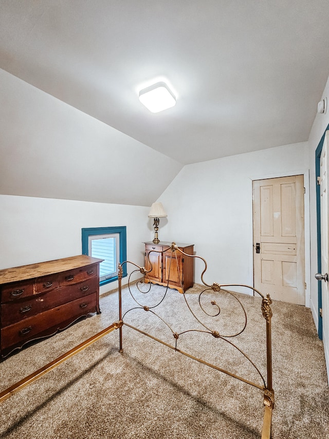 bedroom featuring carpet flooring and lofted ceiling