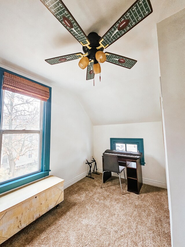 carpeted home office featuring ceiling fan and vaulted ceiling