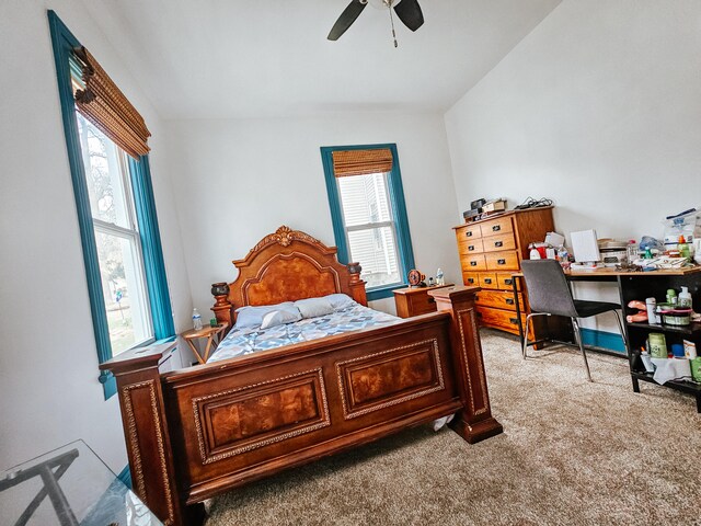 bedroom with ceiling fan, light carpet, and lofted ceiling