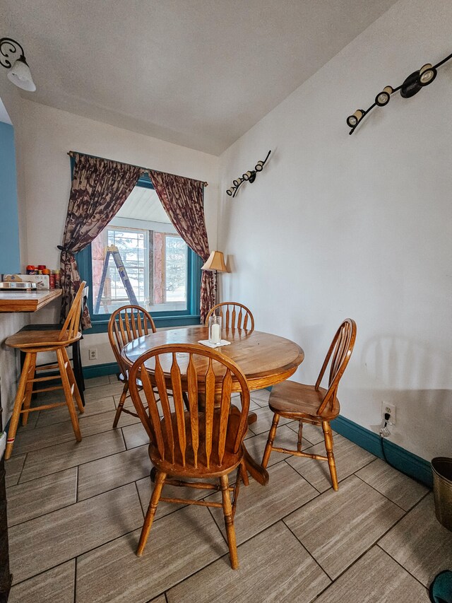 dining space featuring hardwood / wood-style flooring and a textured ceiling