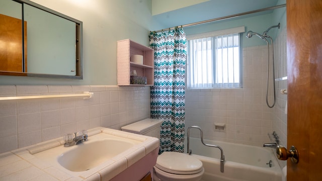 full bathroom with toilet, vanity, shower / tub combo with curtain, and tile walls