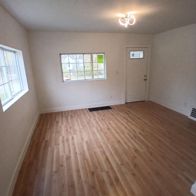 spare room with light hardwood / wood-style floors