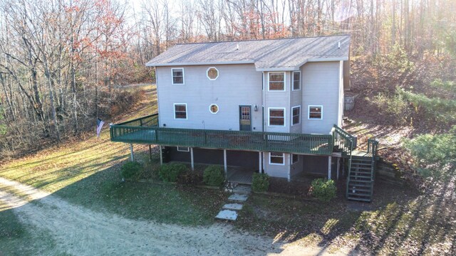 view of front of property featuring a front lawn and a wooden deck