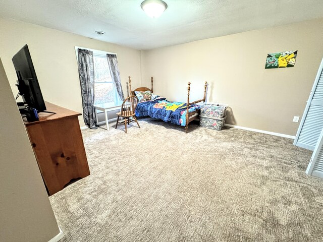 carpeted bedroom featuring a textured ceiling