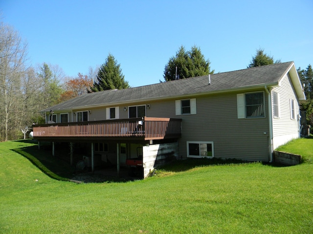 rear view of house featuring a yard and a deck