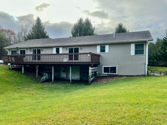 rear view of house with a yard and a deck