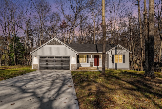 view of front of house with a garage and a yard