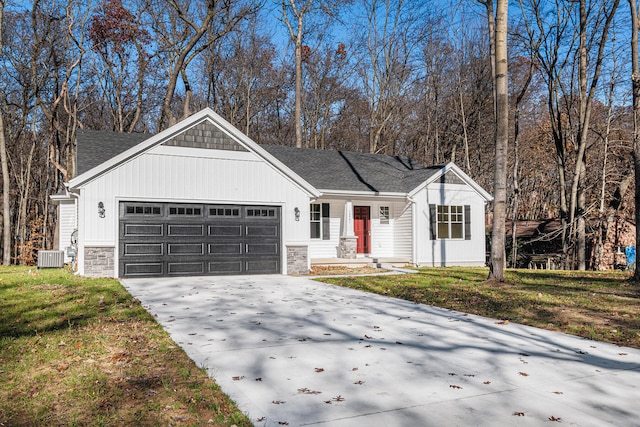 ranch-style house featuring a garage and a front lawn