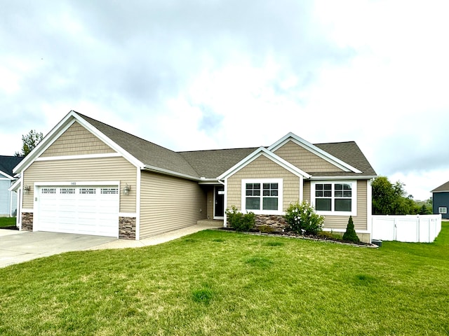 view of front of home with a garage and a front yard