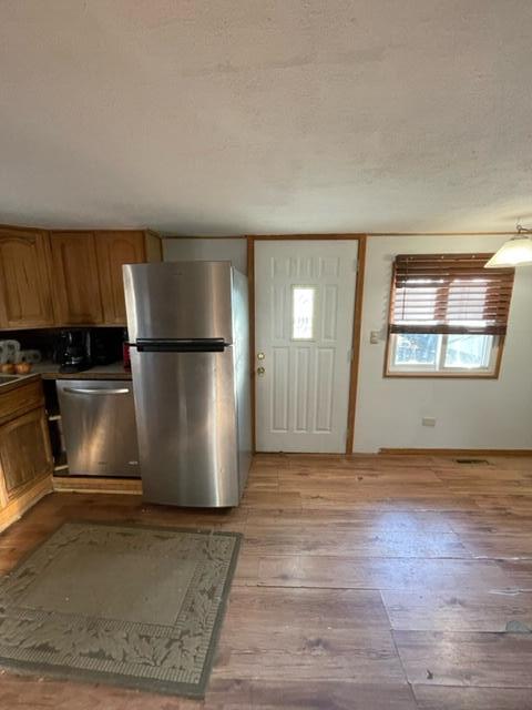 kitchen with light wood-type flooring and stainless steel appliances