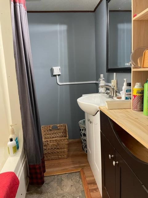 bathroom with vanity, shower / tub combo with curtain, and crown molding