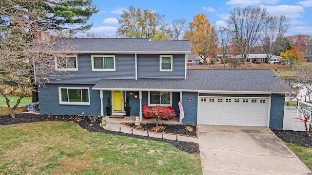 view of property with a garage and a front lawn