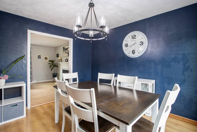 dining room with wood-type flooring and a notable chandelier