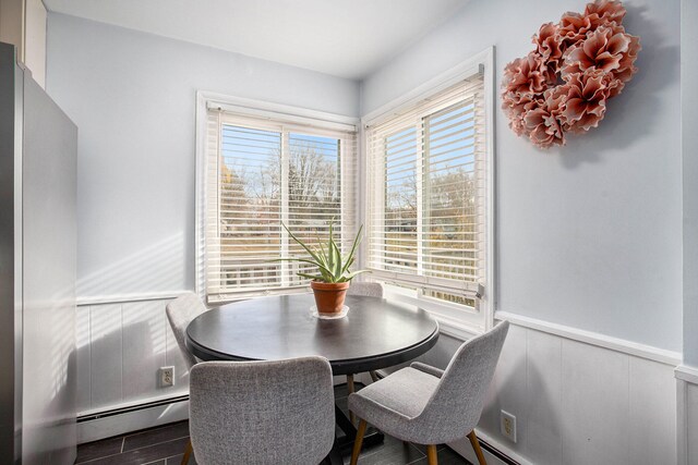 dining room featuring a baseboard radiator and hardwood / wood-style flooring