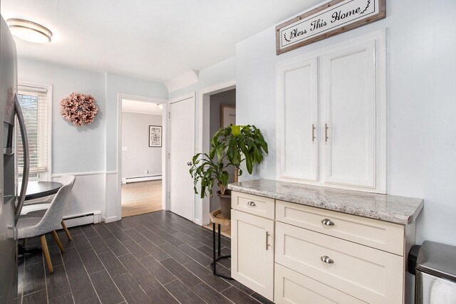 interior space featuring dark wood-type flooring and a baseboard heating unit