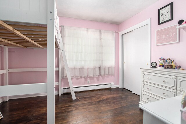 unfurnished bedroom with a baseboard radiator and dark hardwood / wood-style floors