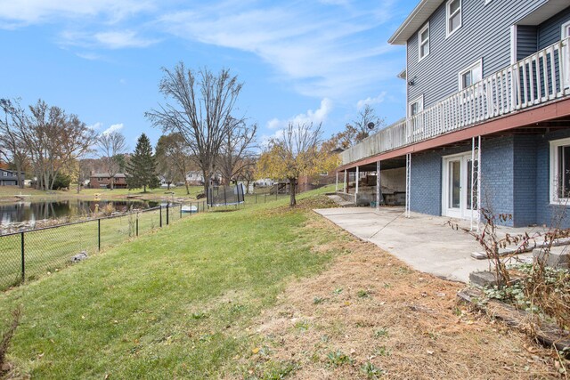 view of yard with a water view and a patio