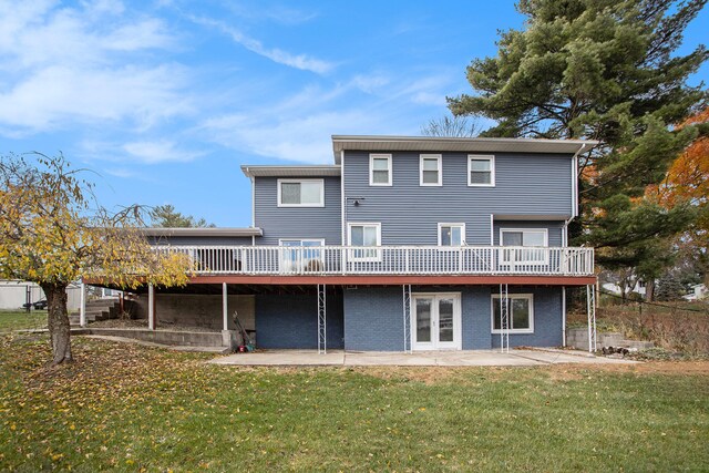 rear view of house with a patio area, a yard, and a deck