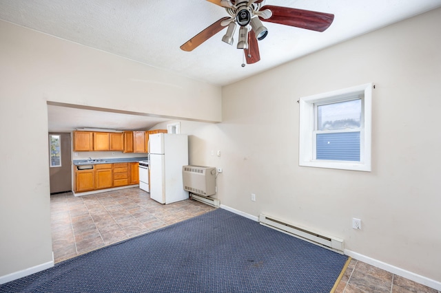 kitchen with heating unit, white appliances, ceiling fan, and a baseboard heating unit