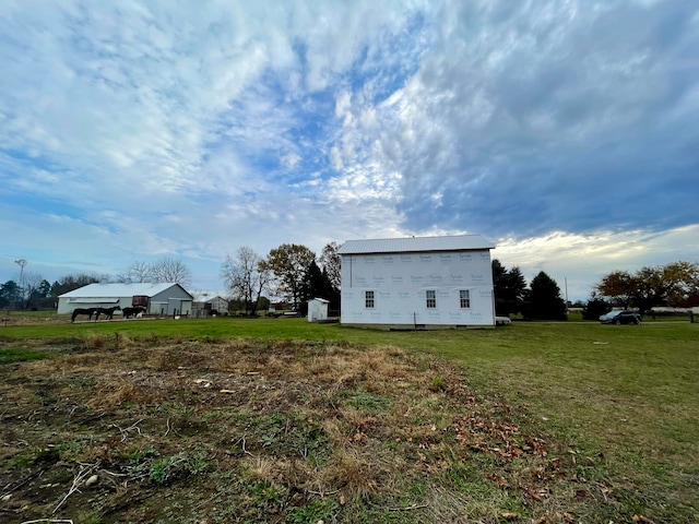 view of side of home with a yard