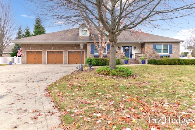 view of front of property with a garage and a front lawn